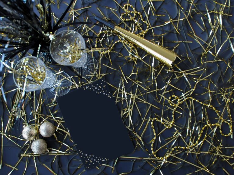New Years Flat Lay with Mockup Friendly Black Card with Space for Text Overlay and Party Favors