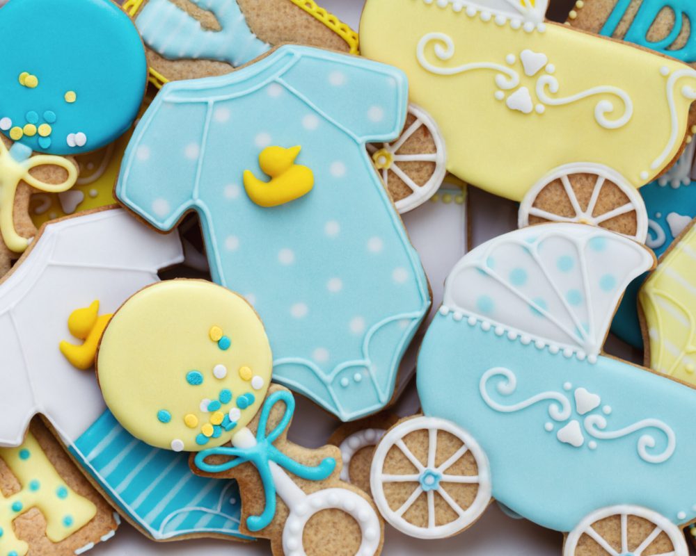 Assortment of decorated baby shower cookies, overhead view