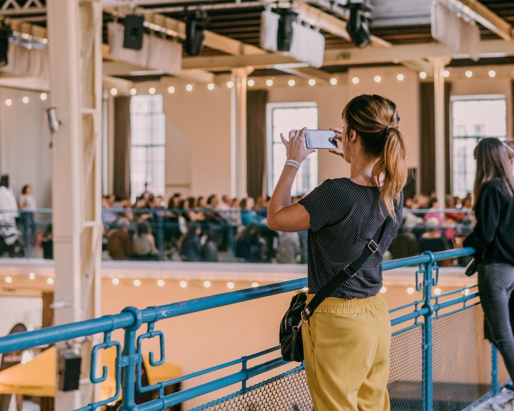 Event venue. Woman taking a picture of an event venue with her mobile phone.