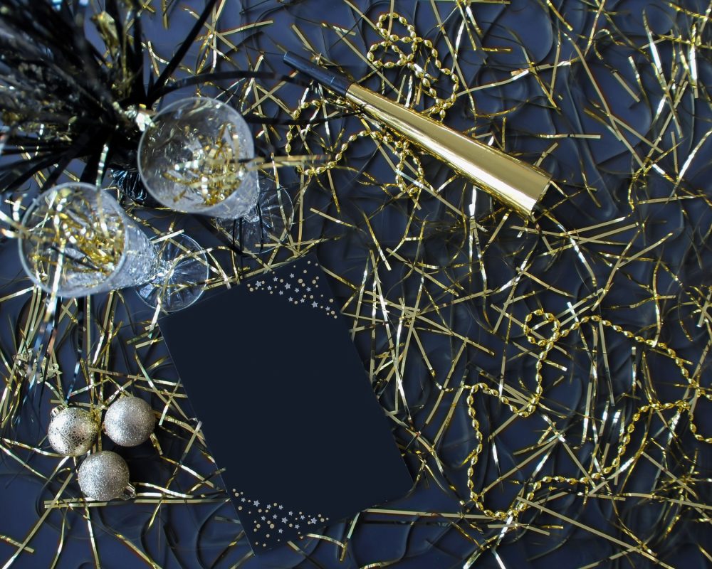 New Years Flat Lay with Mockup Friendly Black Card with Space for Text Overlay and Party Favors