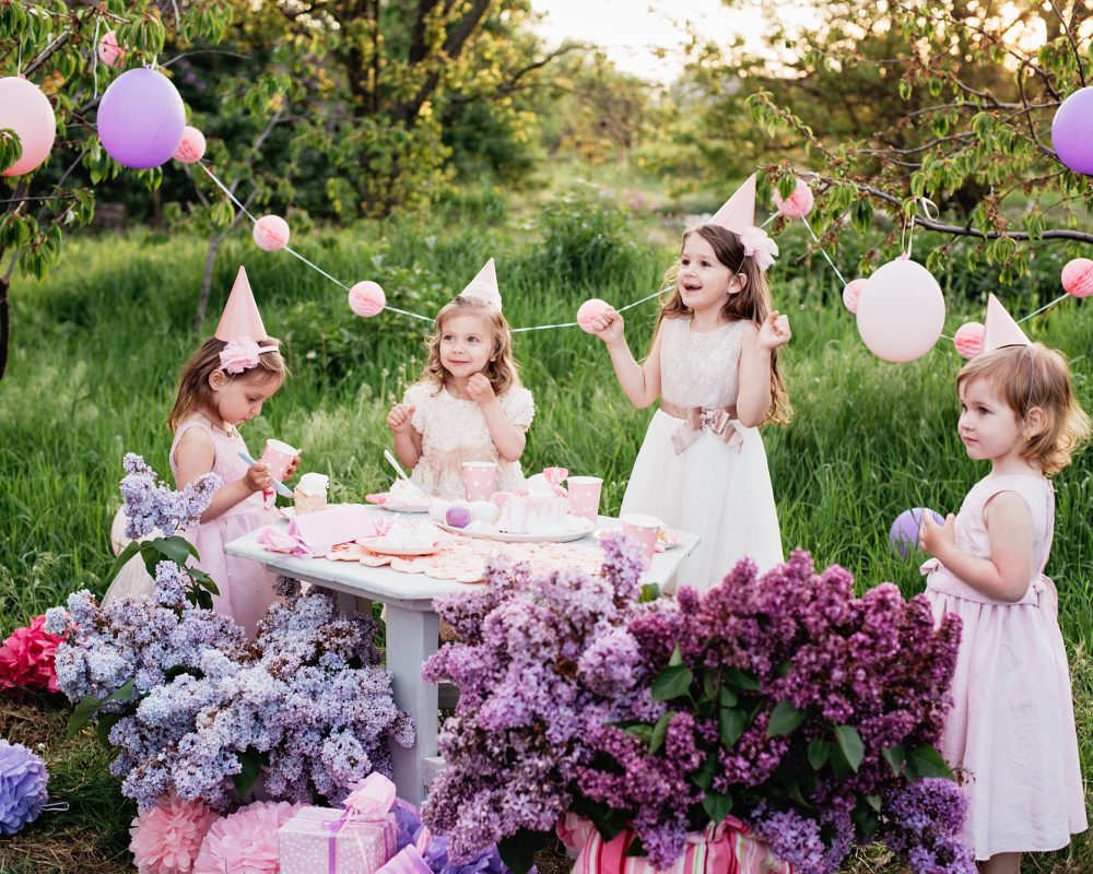 Summer outdoor kids birthday party. Group of happy Children celebrating birthday in park